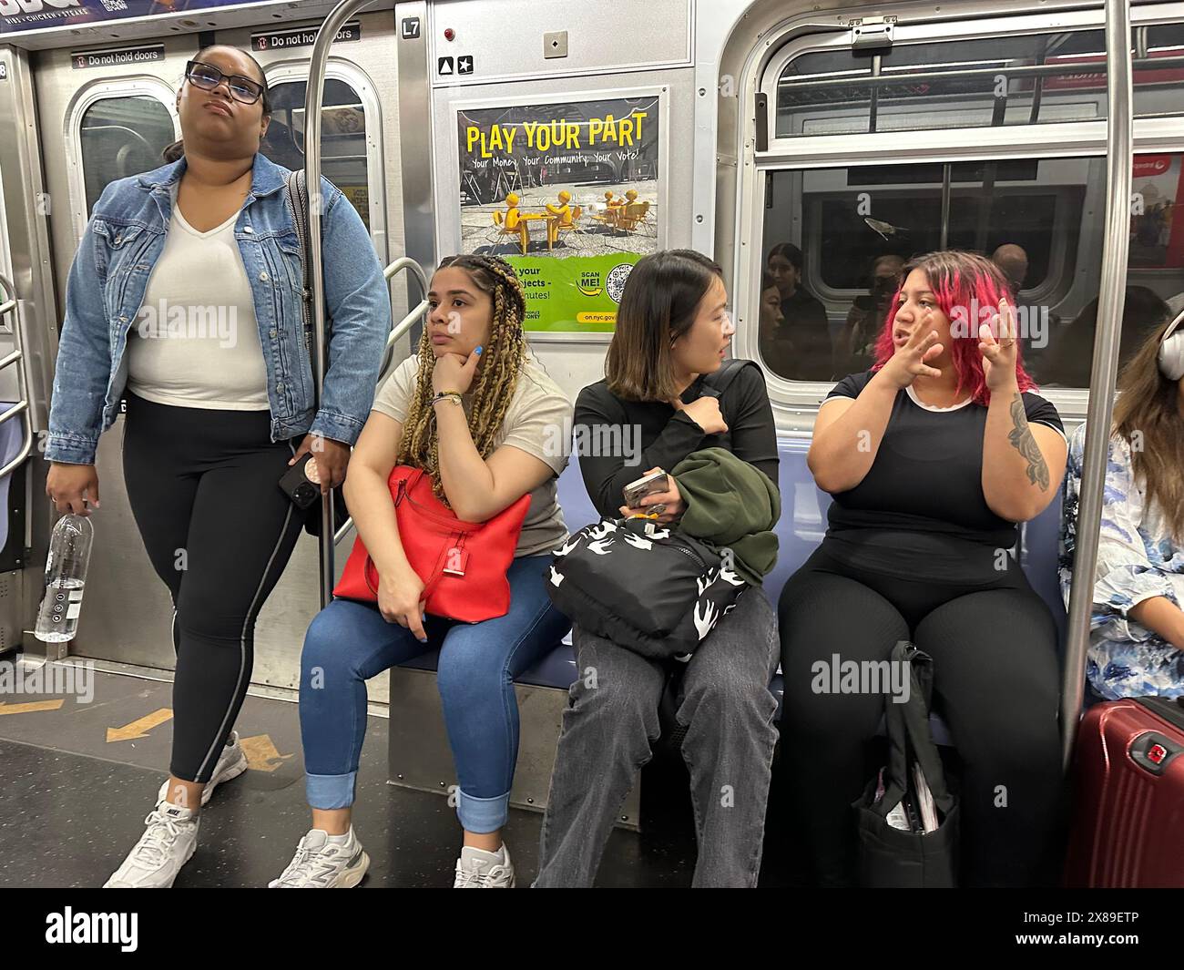 Young women commuters on Manhattan bound train in NYC, NY Stock Photo