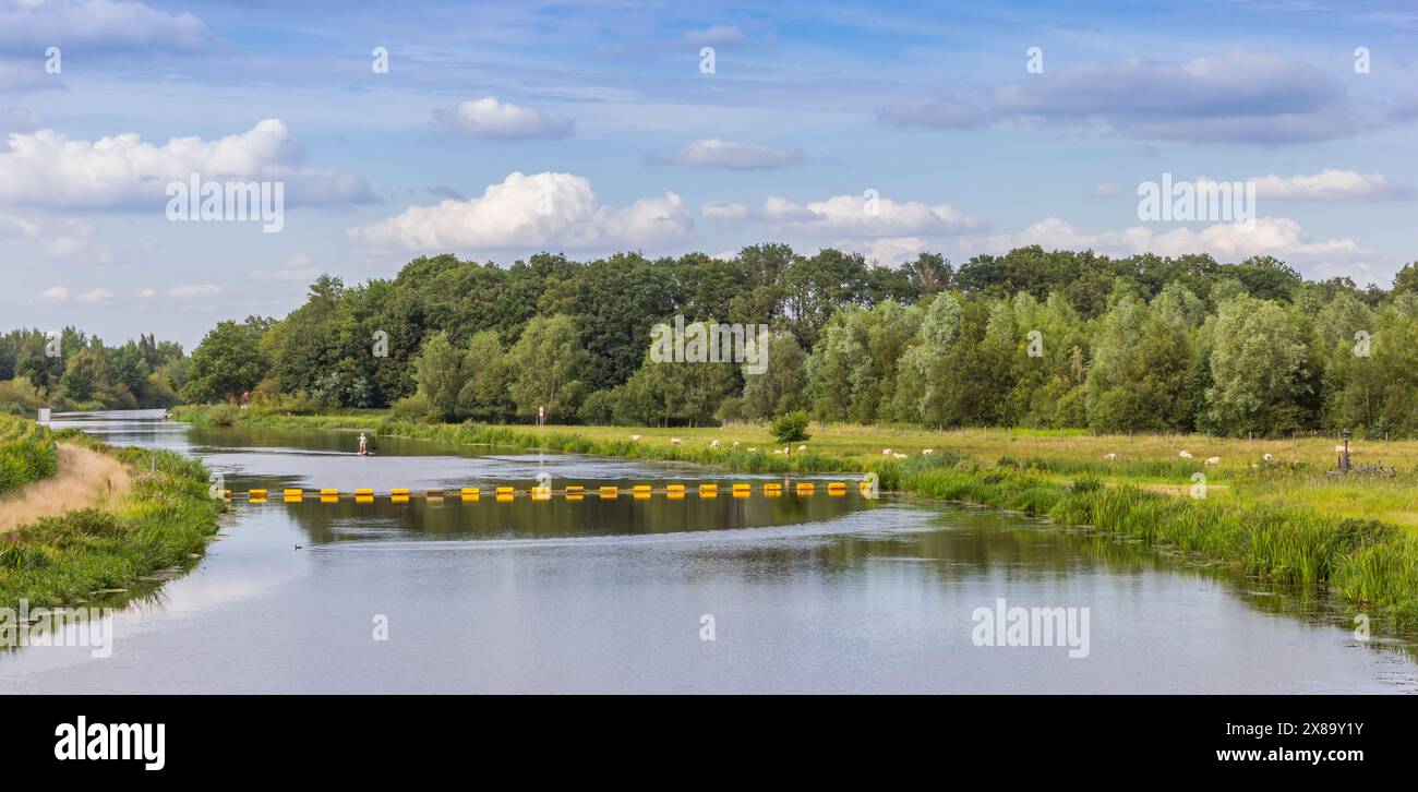 Panorama of the Vecht river with grazing sheep near Hardenberg, Netherlands Stock Photo