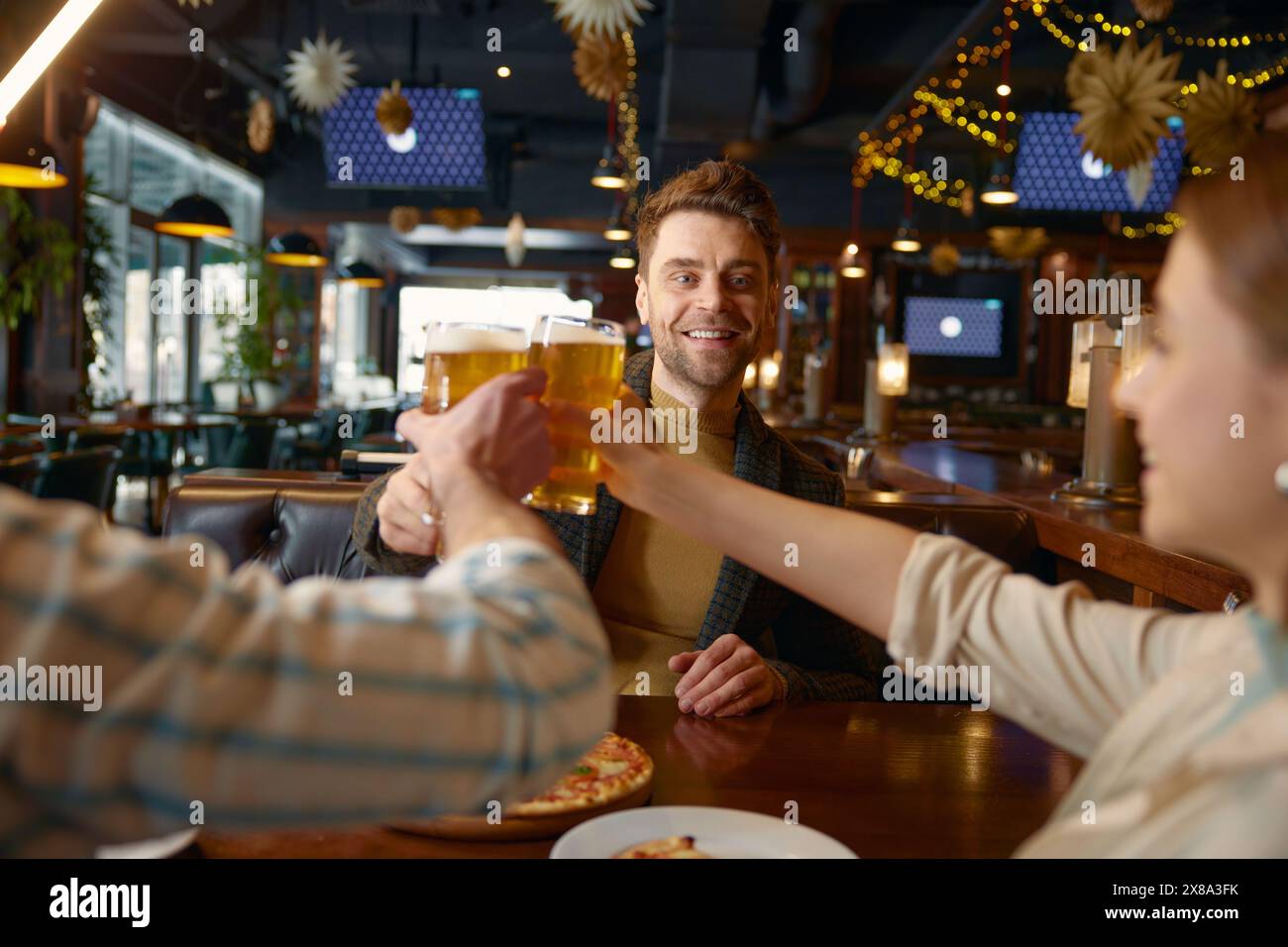 Friends drinking beer while rest in pub Stock Photo
