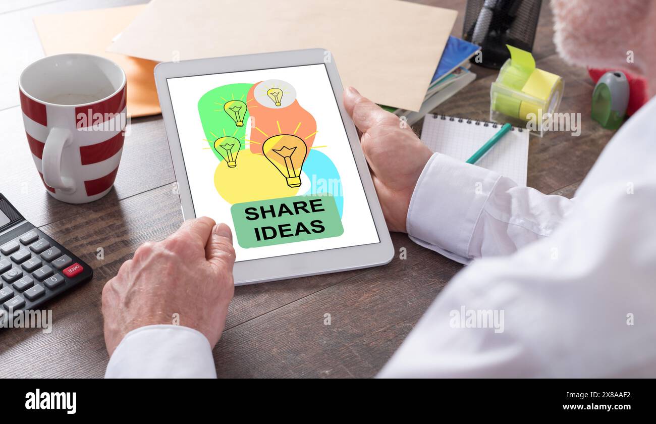 Share ideas concept shown on a tablet held by a man Stock Photo
