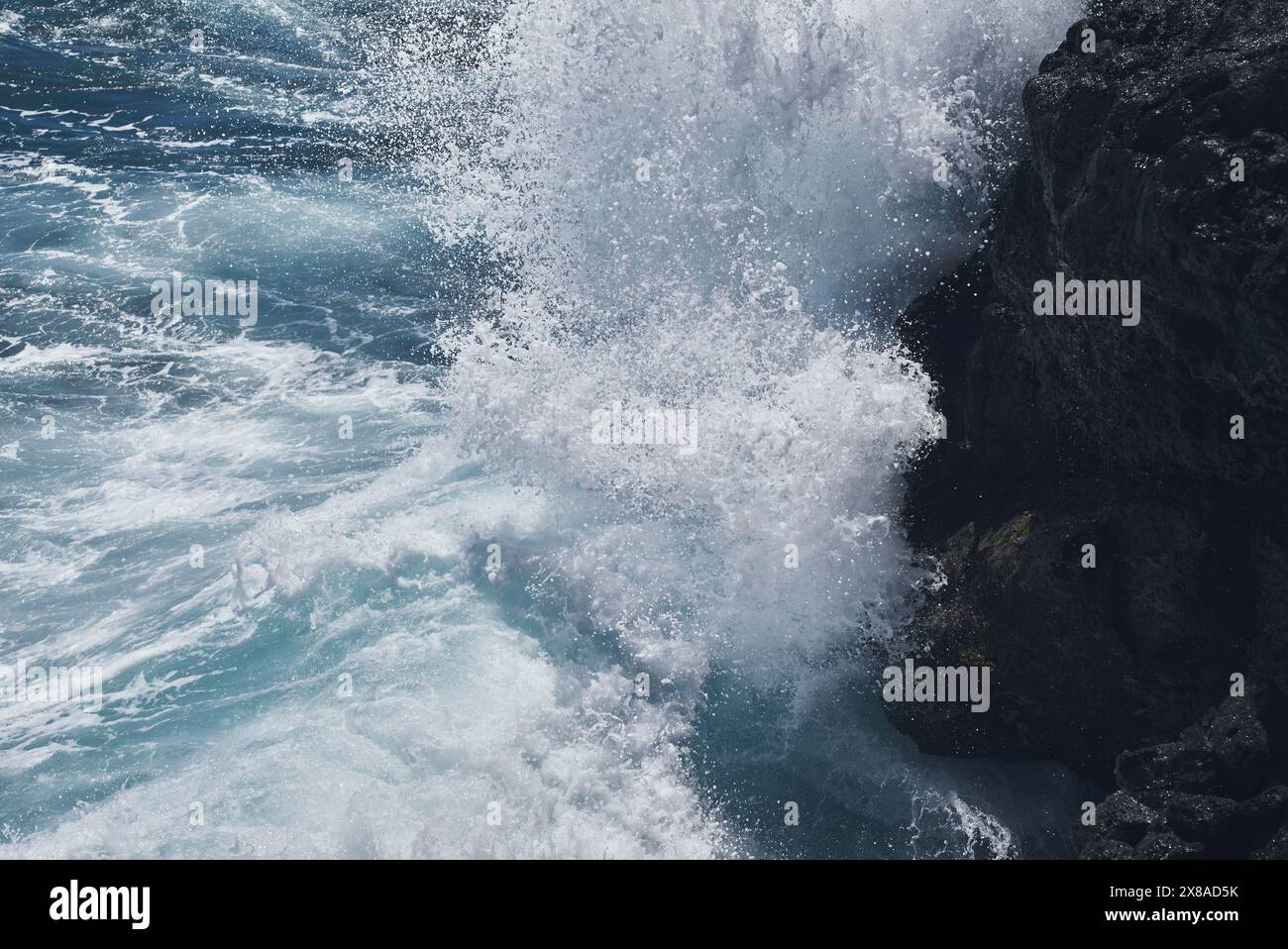 Waves crashing on rock Stock Photo