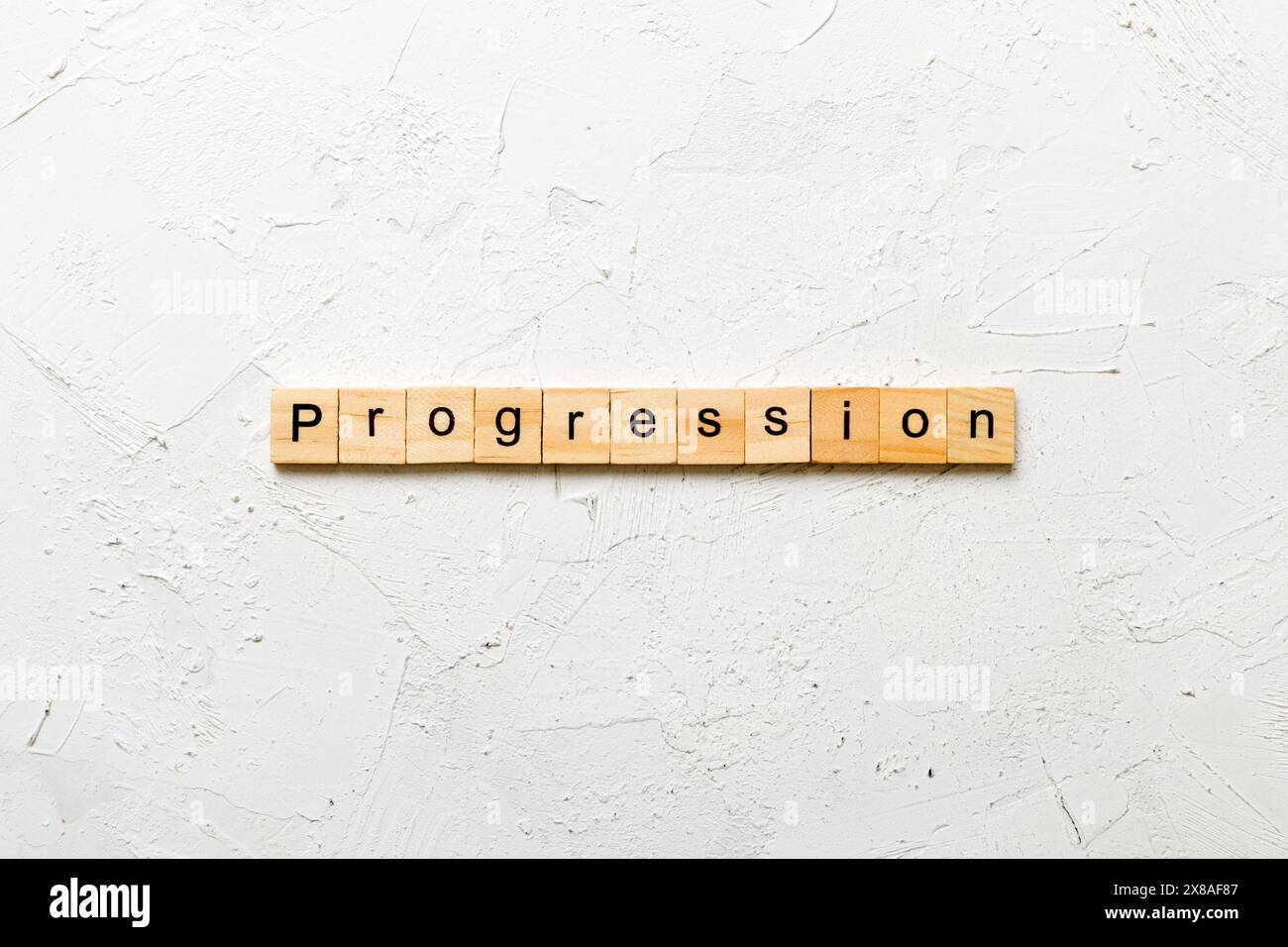 progression word written on wood block. progression text on cement ...