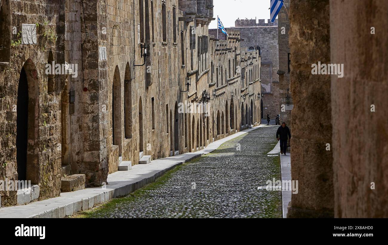 A medieval street with cobblestones and historic stone buildings, quiet ...