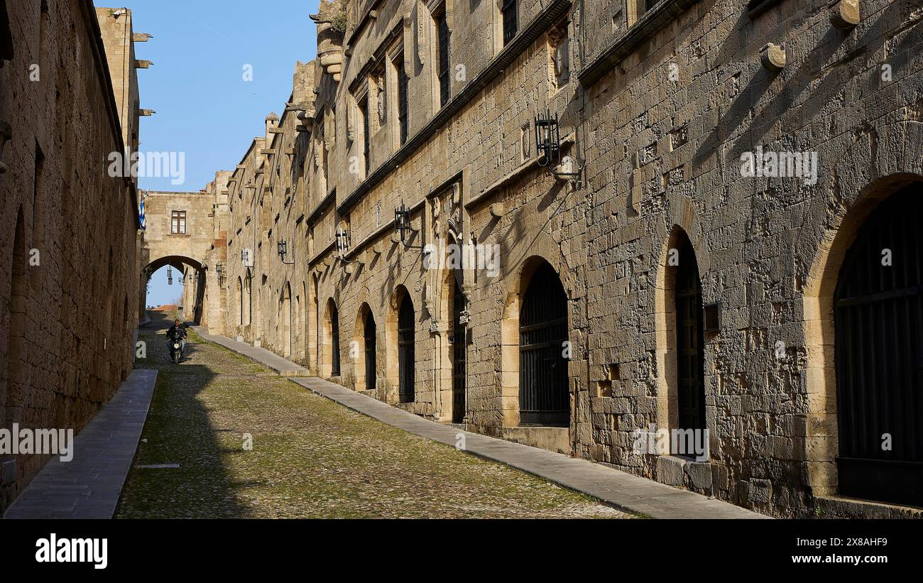 An ancient street lined with historic buildings with arcades in sunny ...