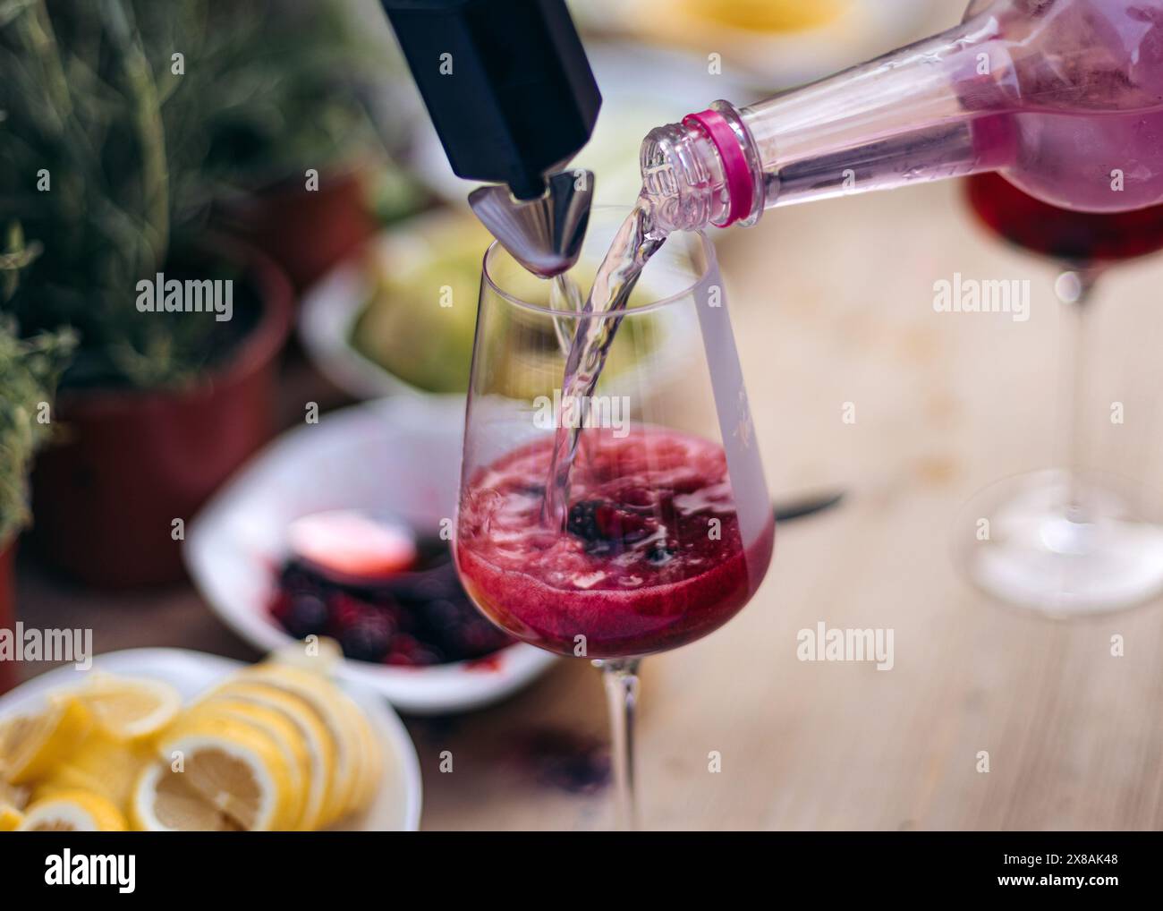 Pouring a refreshing berry drink into a glass Stock Photo - Alamy