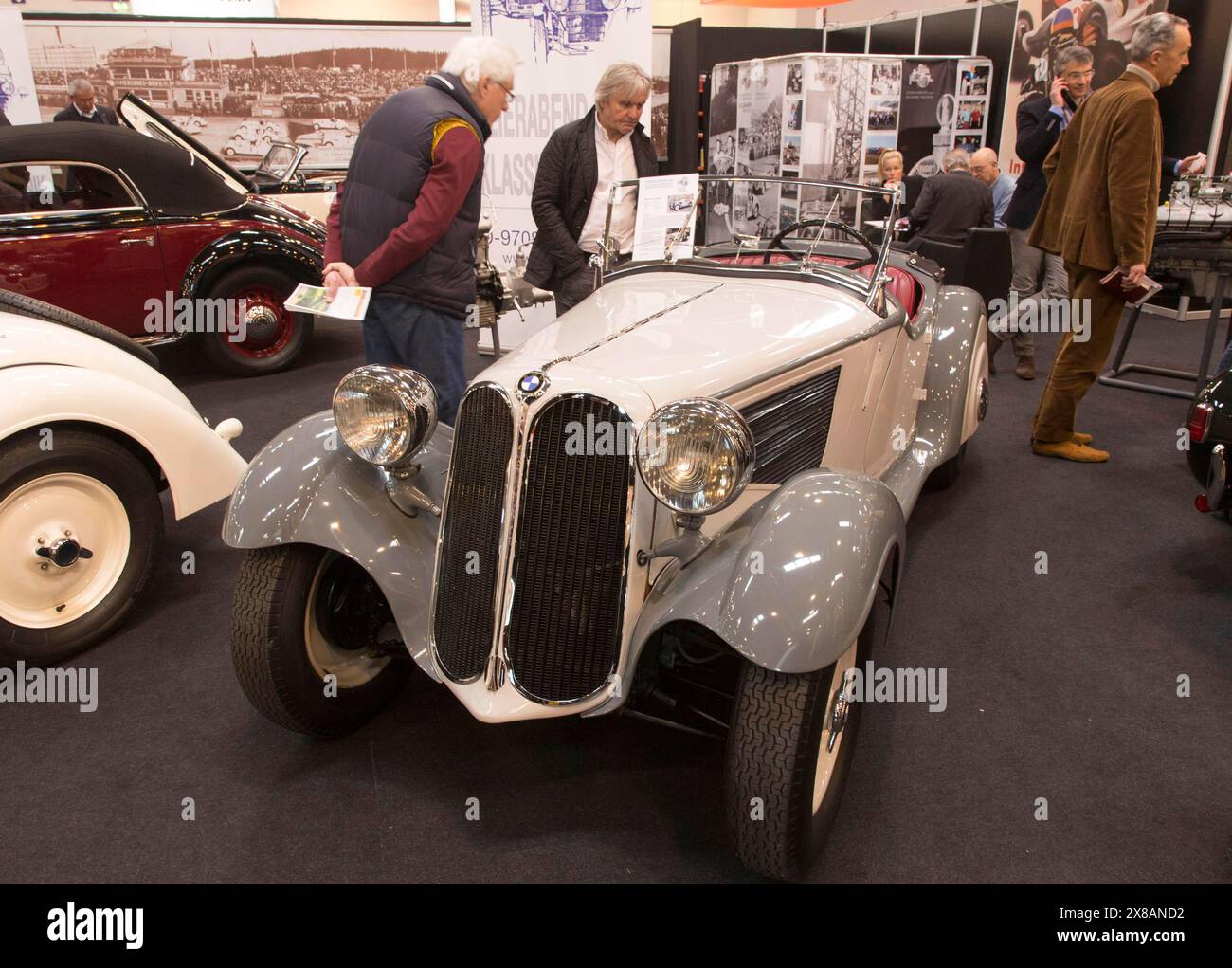 Visitors to Techno Classica take a look at a BMW 319/1 Roadster. Techno Classica is the trade fair for vintage, classic and prestige cars, motorsport, Stock Photo