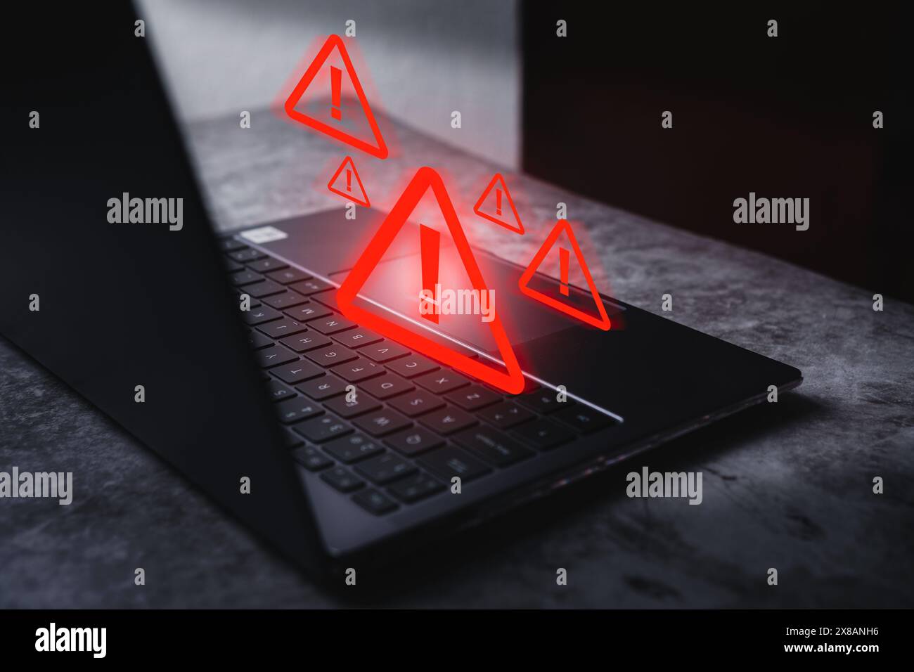 Laptop with hologram warning sign for notification error. Programmer, developer and maintenance system concept. Scam virus attack. Stock Photo