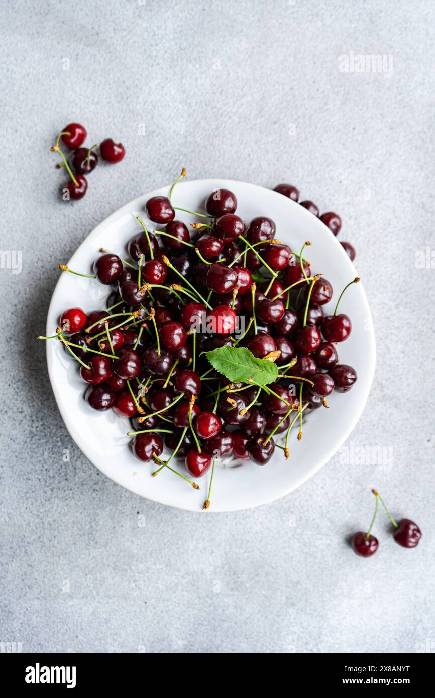 Fresh organic sweet cherry berries on concrete background Stock Photo