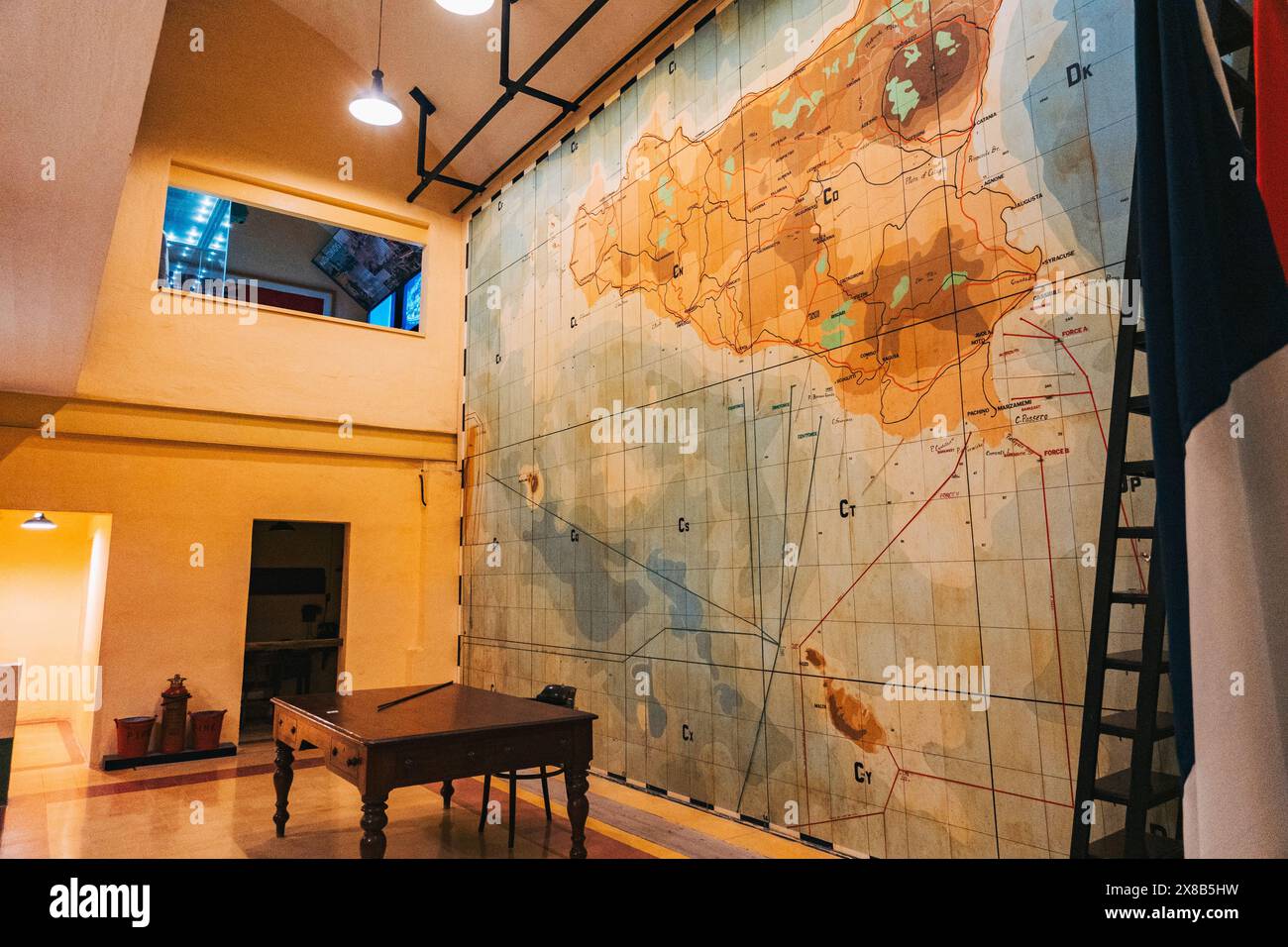 Large map hangs hi res stock photography - A Large Map Of Sicily Hangs On The Wall Of A World War Ii Era Bunker At The Lascaris War Rooms Museum Malta Featuring A Wooden Desk And A Ladder 2X8B5HW