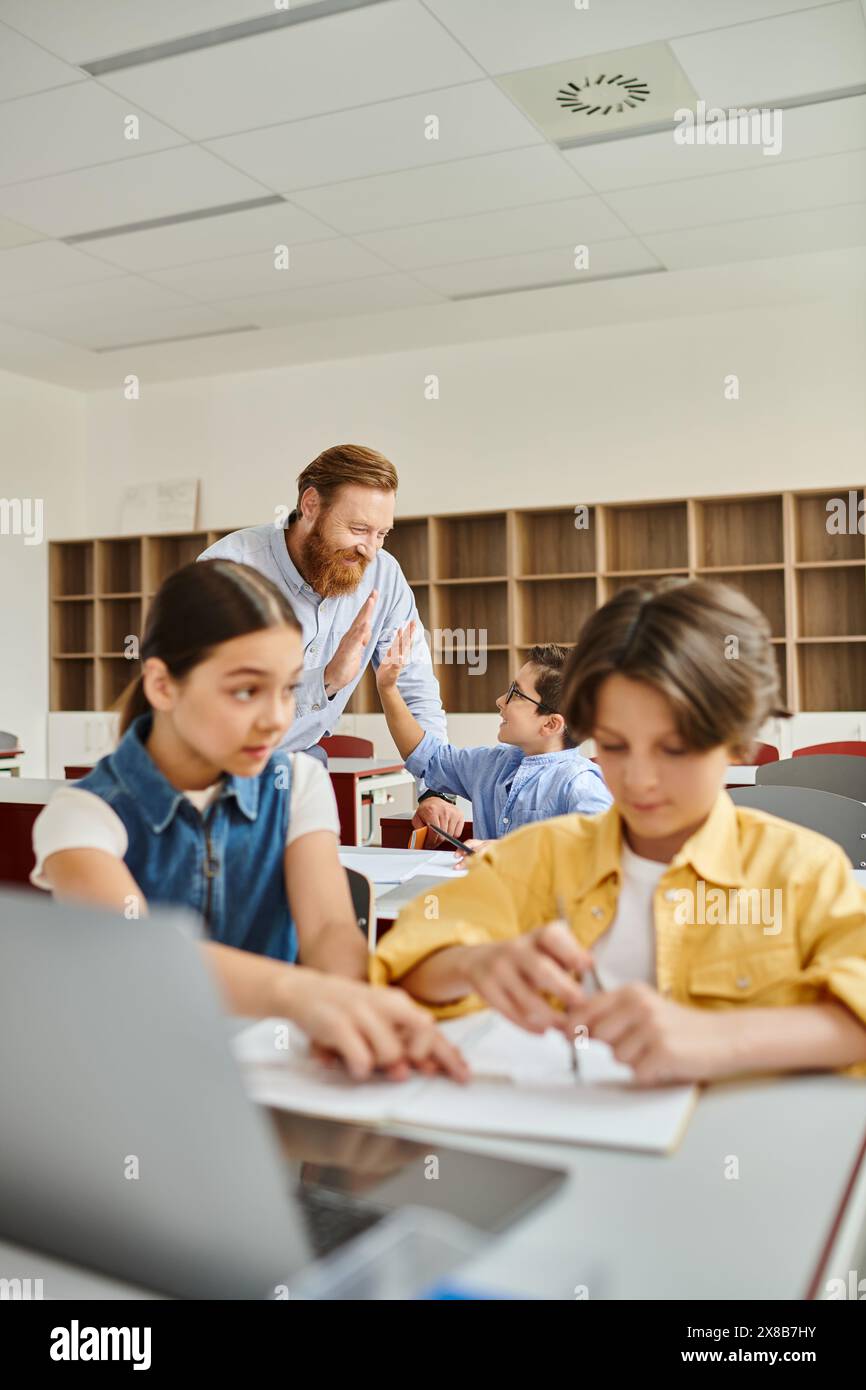 A group of people, including a man teacher, sitting at desks in a bright, lively classroom, engaging in a lesson. Stock Photo