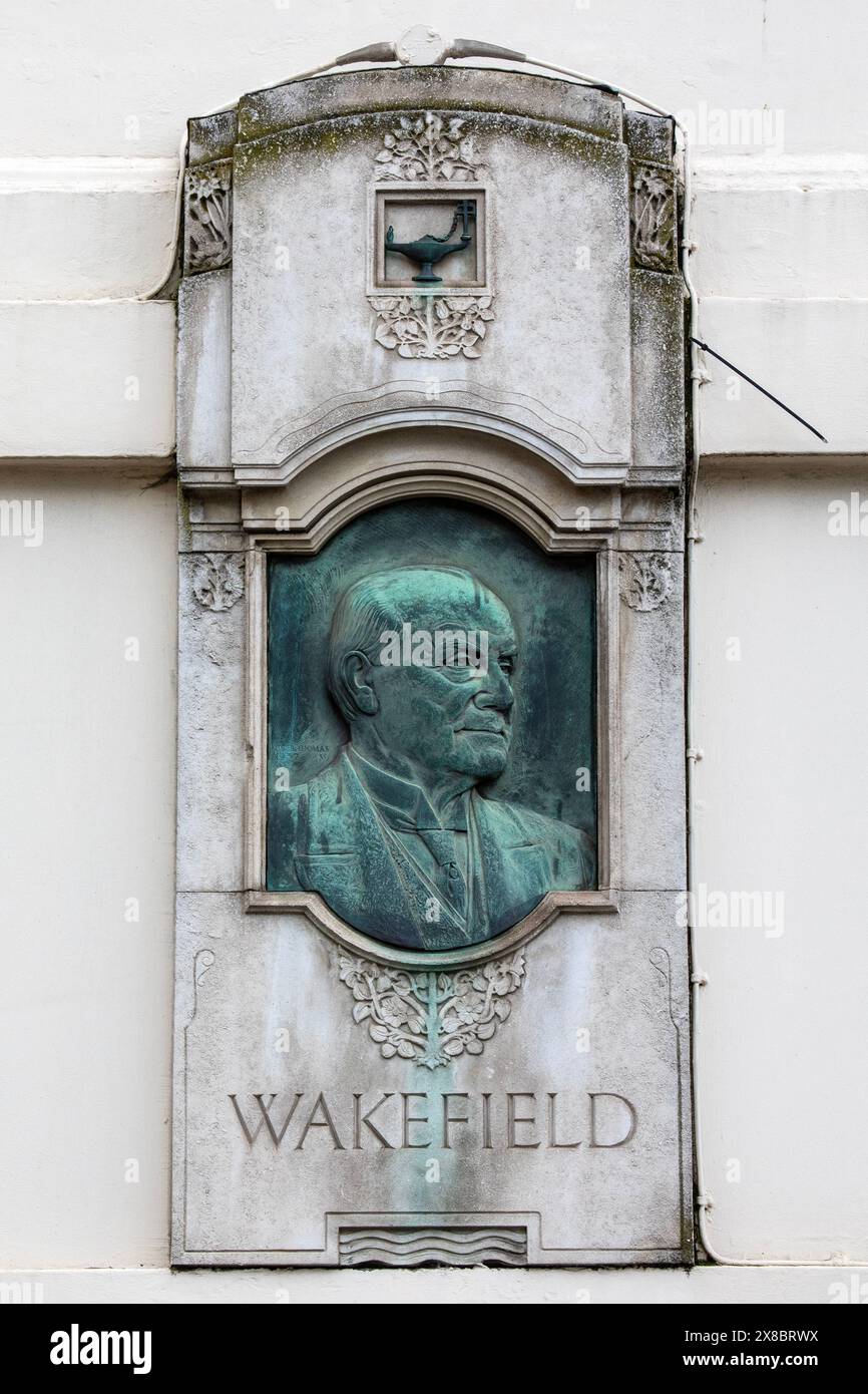 London, UK - April 3rd 2024: A sculptured plaque commemorating English businessman Viscount Wakefield, located on Trinity Square in London, UK. Stock Photo