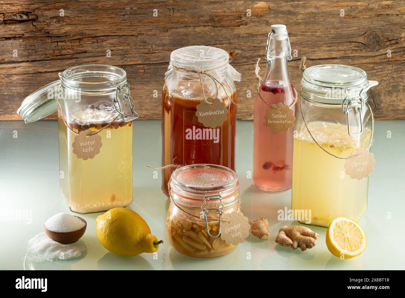 Fermented probiotic beverages - Water Kefir, Kobucha, Ginger Ale, Ginger Bug with cardboard signs and fruits Stock Photo