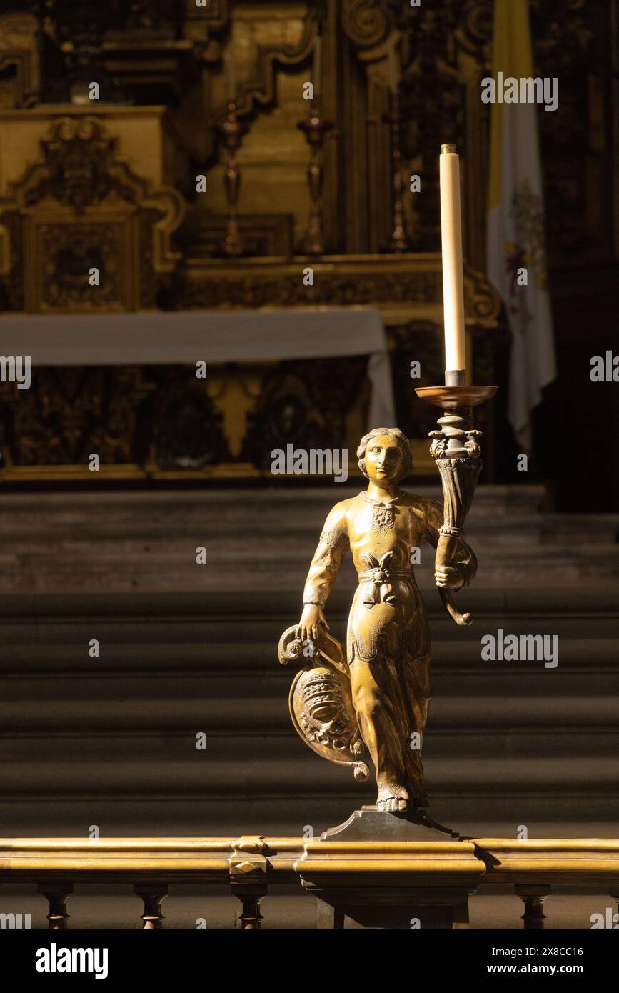 Mexico City Cathedral interior; Religious statue and candle at The Altar of the Kings; Religious Roman Catholic statue artifact, Mexico City, Mexico Stock Photo