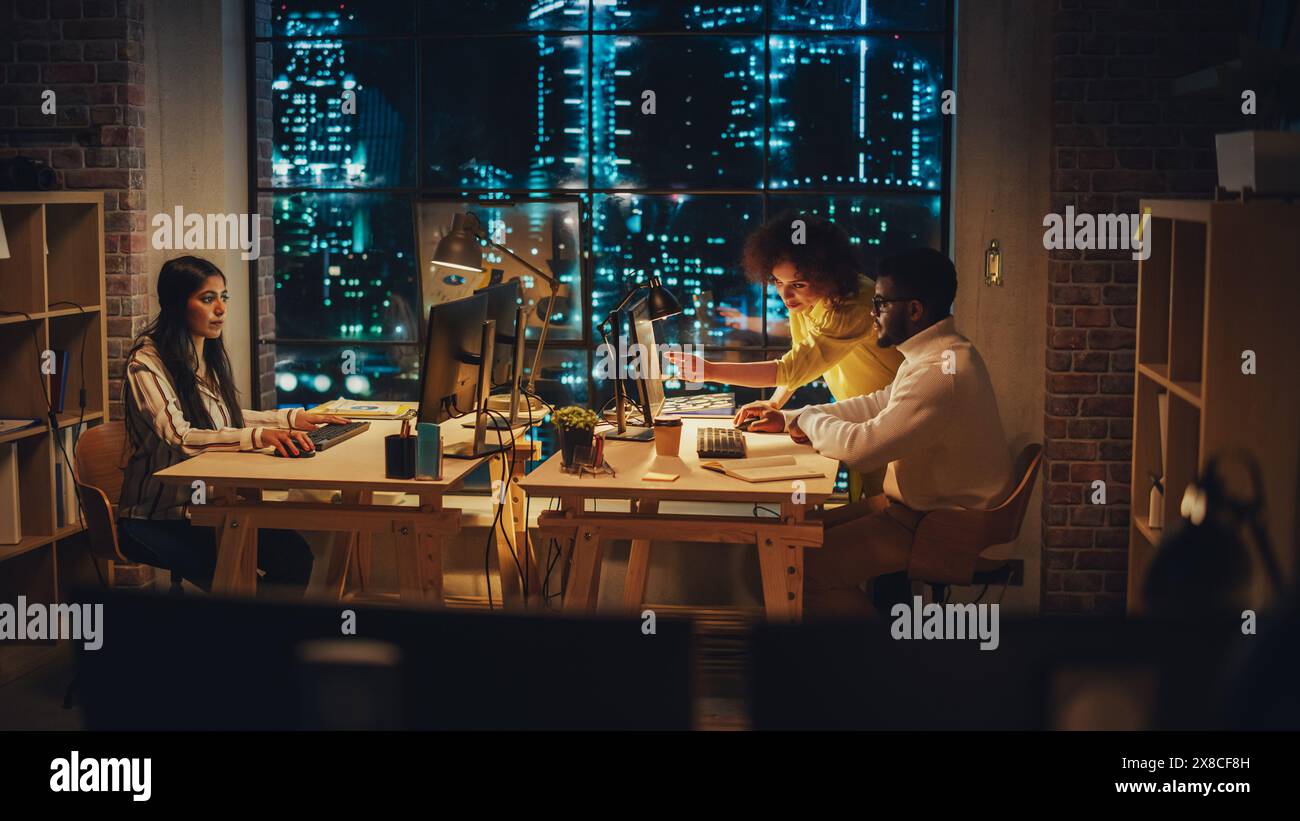 Small Creative Multicultural Team Collaborate on a Project and Work Together as a Team. Project Manager and Software Developer Talking and Discussing Changes to Document. Evening at Work. Stock Photo
