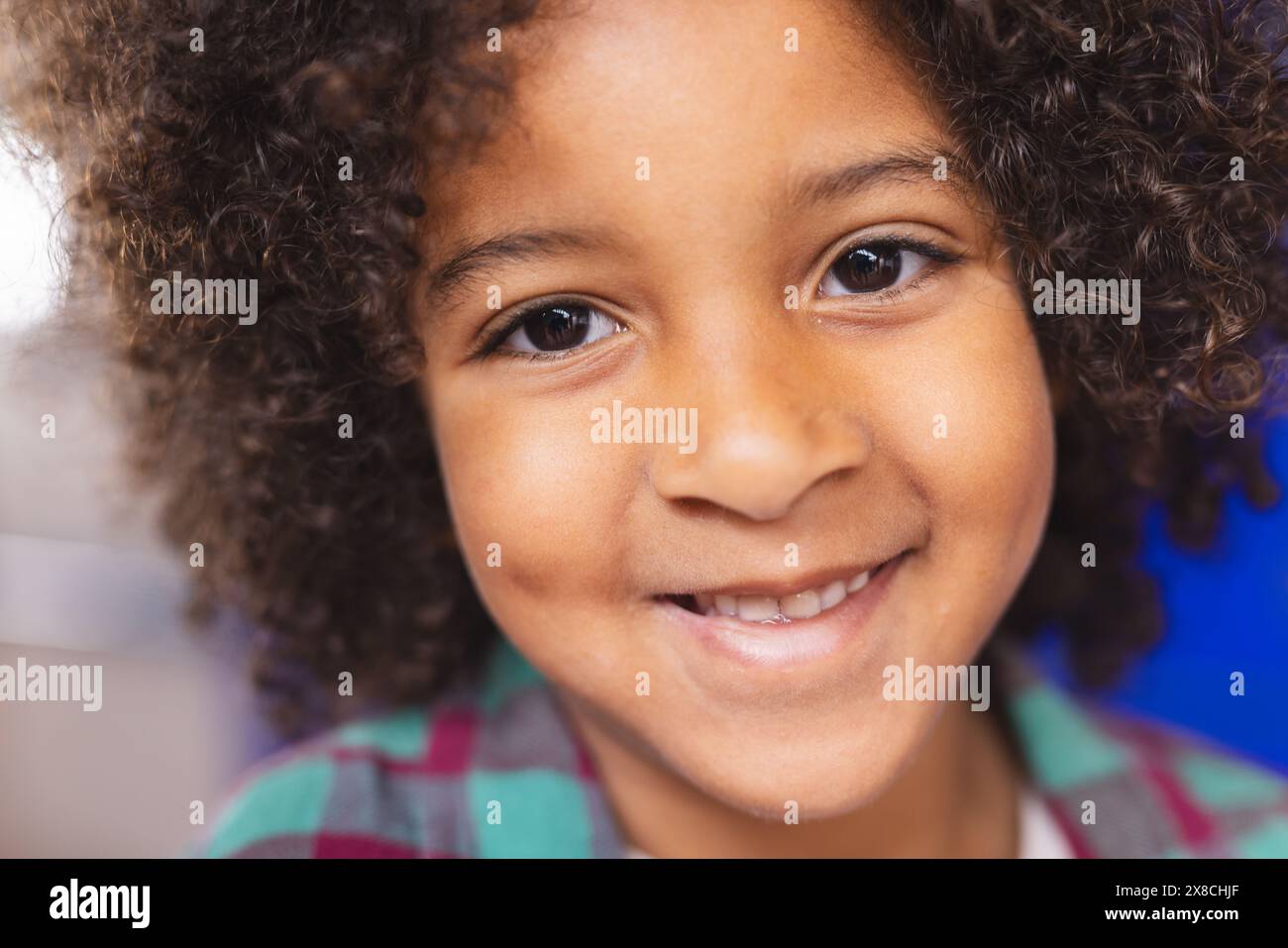 In school, young biracial boy is smiling at camera Stock Photo - Alamy