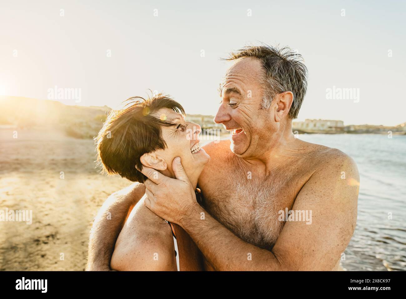Happy senior couple enjoying vacations on the beach - Elderly people love concept Stock Photo