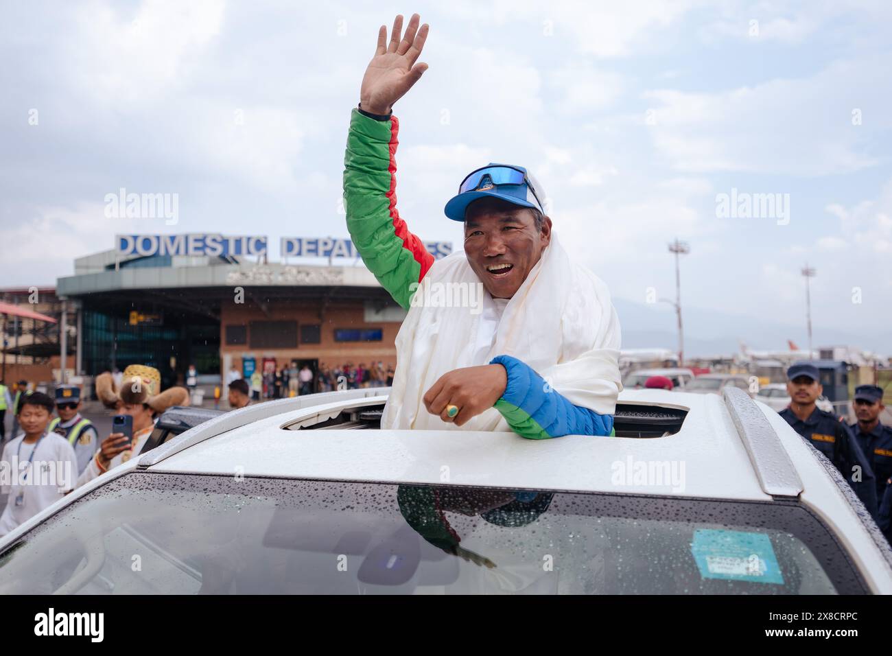 Kathmandu, Nepal. 24th May, 2024. Legendary Mountaineer Kami Rita Sherpa waves at people as he arrives after scaling Mt Everest for the 30th time, leading the world record of most ascents on the world's highest peak Mount Everest at Tribhuvan International Airport. Kami Rita Sherpa, considered one of the greatest mountain guides, reached the 8,849-meter (29,032-foot) summit at 7:49 AM local time on Wednesday 22 May, 2024 according to expedition organizer Seven Summits Treks. Credit: SOPA Images Limited/Alamy Live News Stock Photo