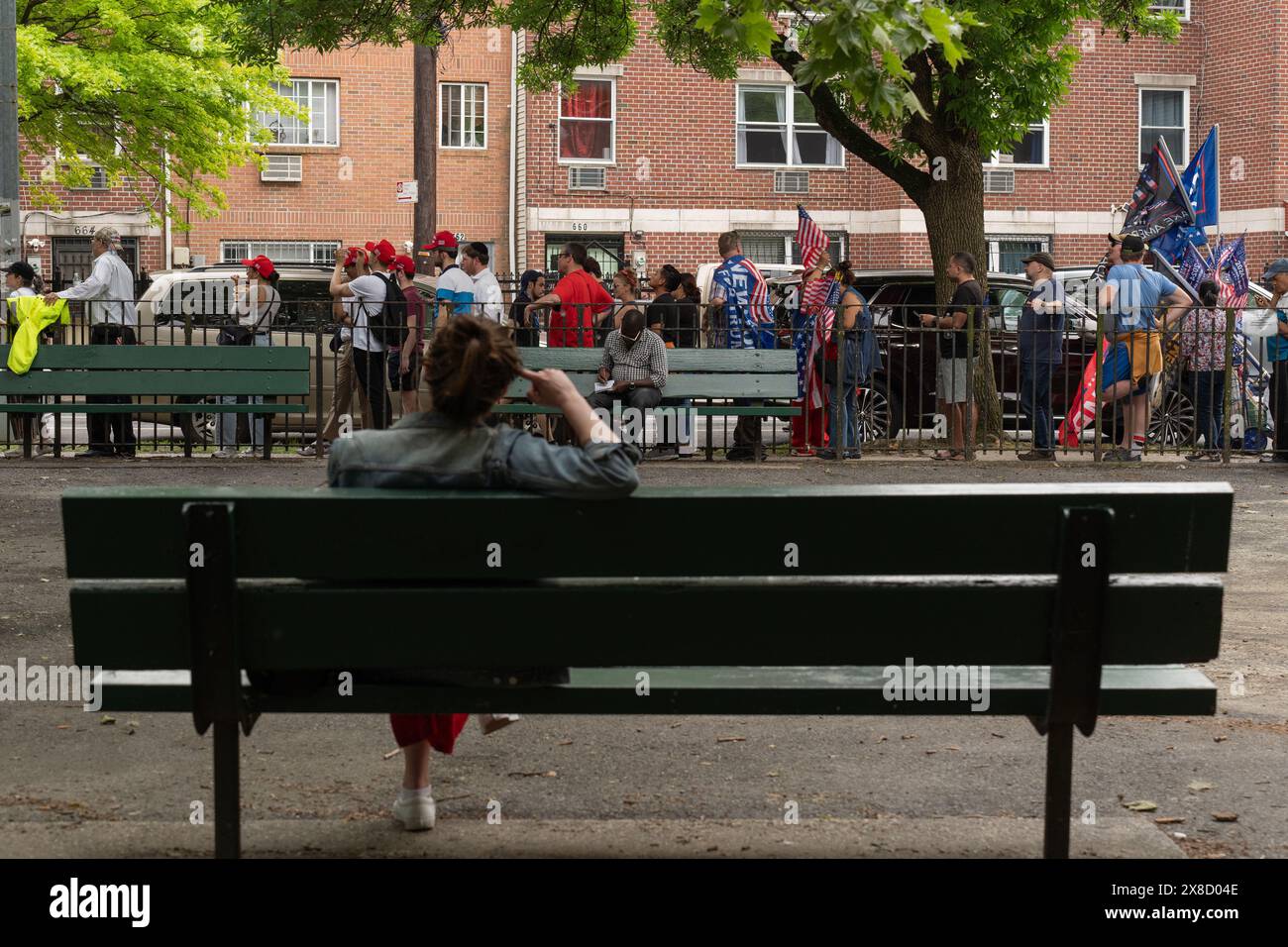 Bronx, USA. 23rd May, 2024. A woman watches Trump supporters wait in line during a campaign event with former US President Donald Trump at Crotona Park in the Bronx. (Credit Image: © Derek French/SOPA Images via ZUMA Press Wire) EDITORIAL USAGE ONLY! Not for Commercial USAGE! Stock Photo