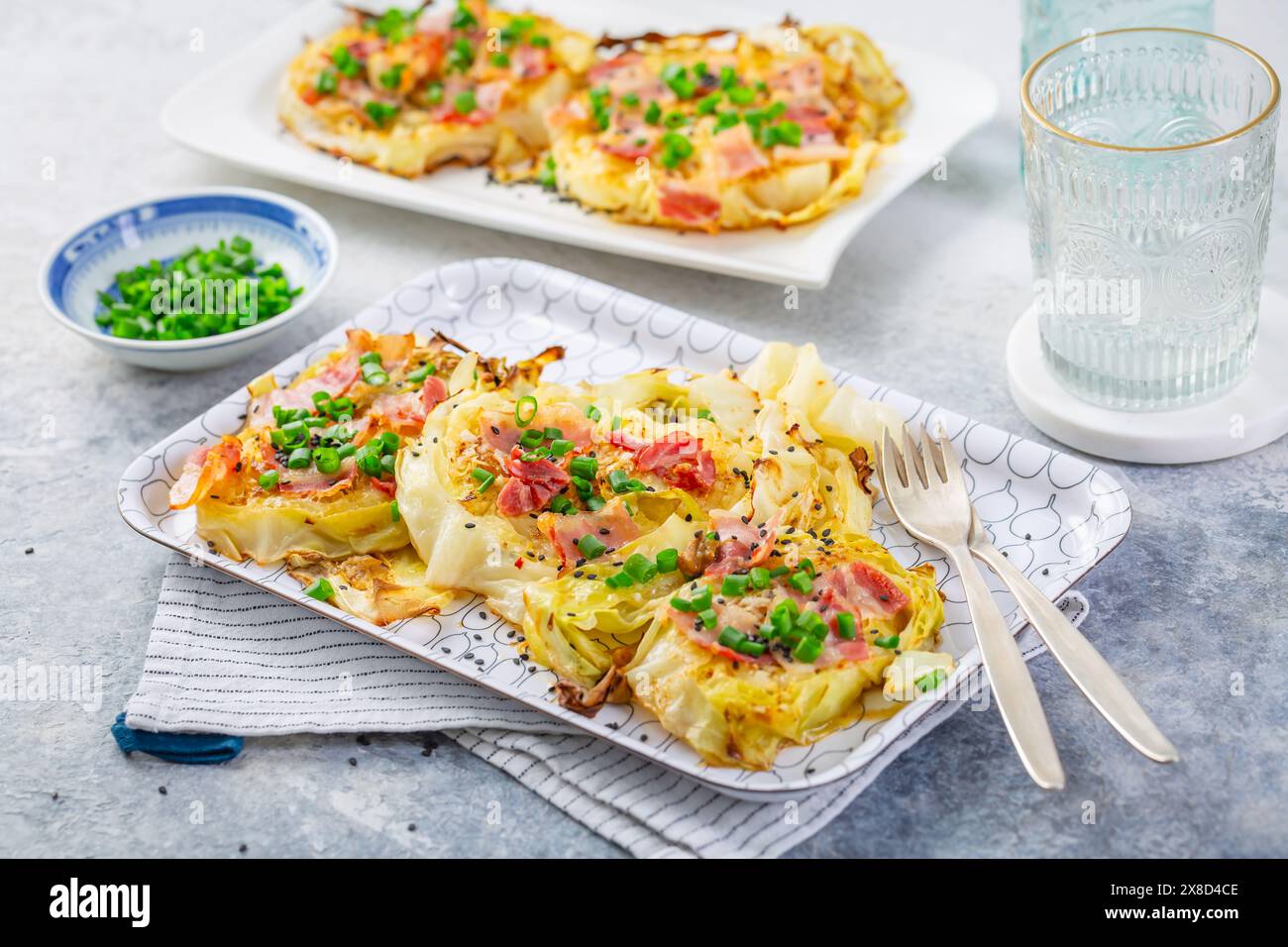 Oven baked cabbage steaks with parmesan, bacon and green onions Stock