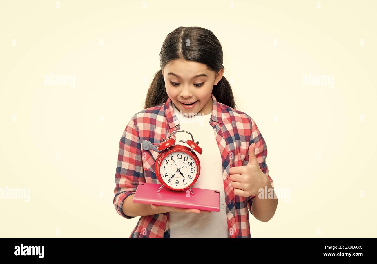 teen school girl with alarm clock in studio. school girl with alarm ...