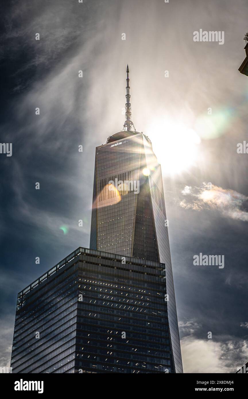 NYC's towering One World Trade Center pierces the sky during the Solar Eclipse 2024. A symbol of resilience for travel and architecture content. Stock Photo