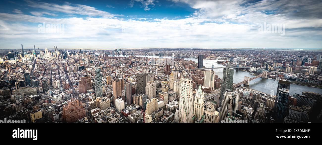 Witness the awe-inspiring sprawl of Manhattan's skyscrapers from a daring perspective below. Towering giants pierce the clouds, offering unique view. Stock Photo