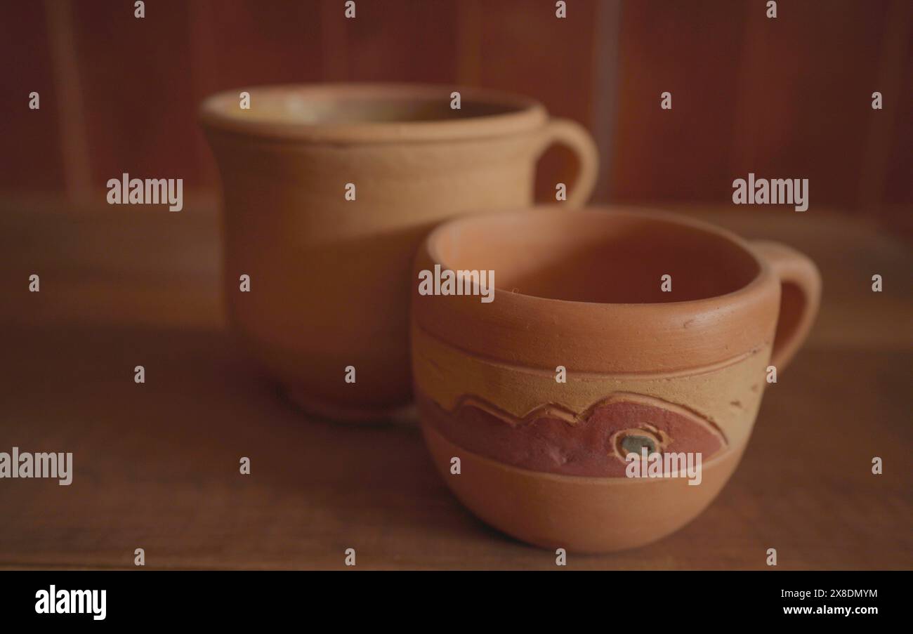 Empty earthenware mug on wooden table background. Stock Photo