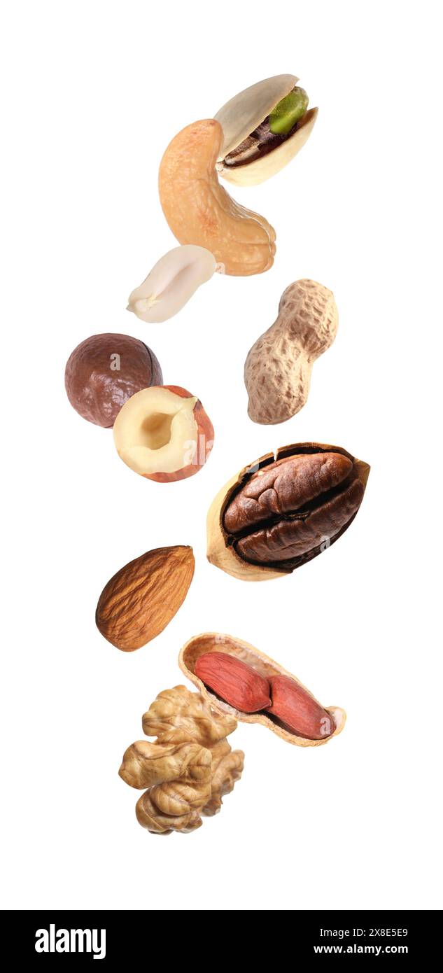 Many different nuts in air on white background Stock Photo