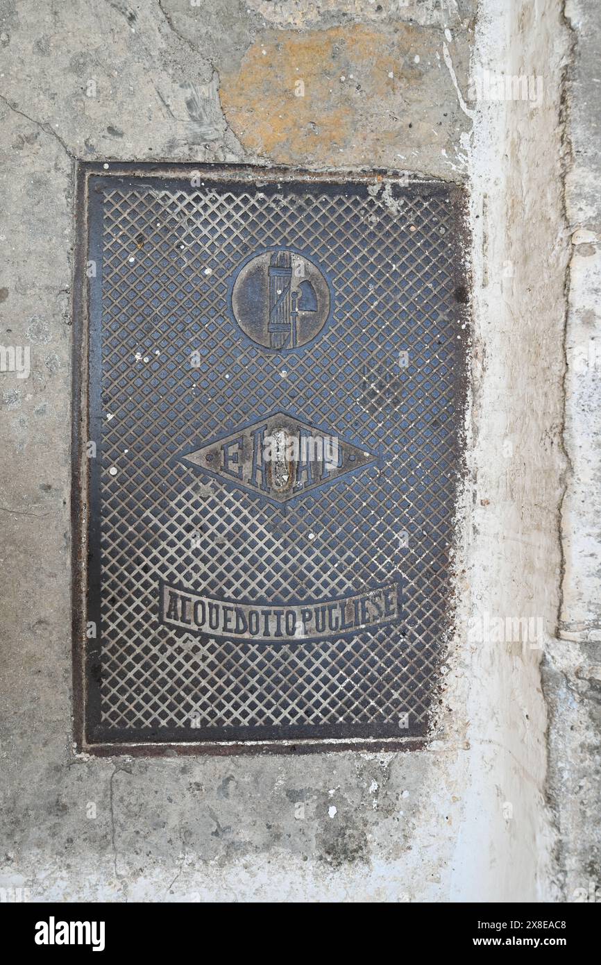 Sewer Grate in Ostuni, Italy with the symbol of the Fascists. Stock Photo