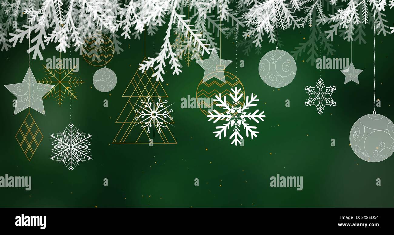 Snowflakes and ornaments hanging against dark green background Stock Photo