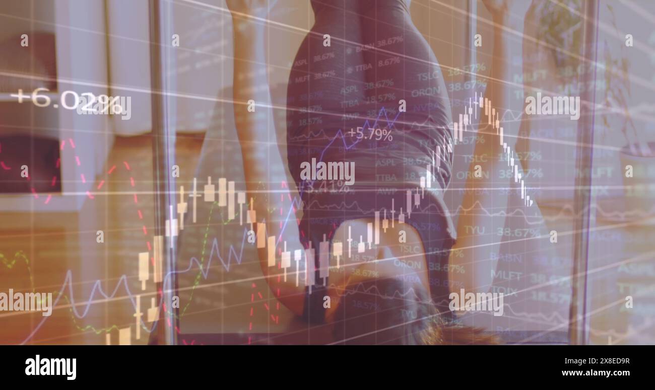 Caucasian woman examining stock market graphs on glass Stock Photo
