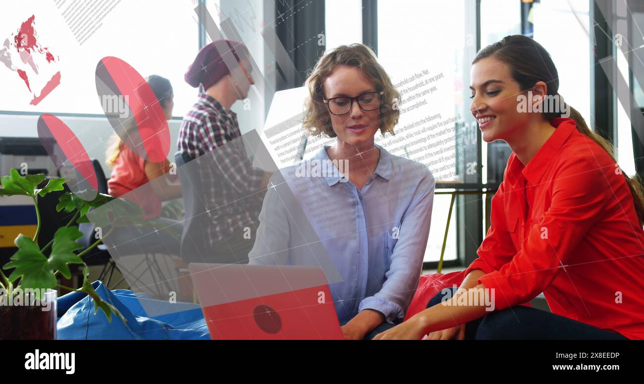 Image of statistical data processing over two diverse women discussing over laptop at office Stock Photo