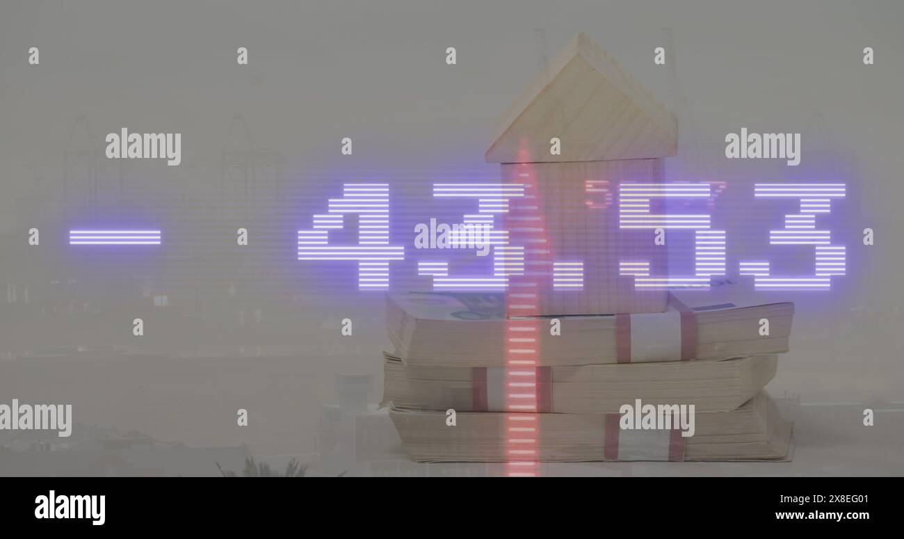 Image of stock market data processing over wooden house model against view of cityscape Stock Photo