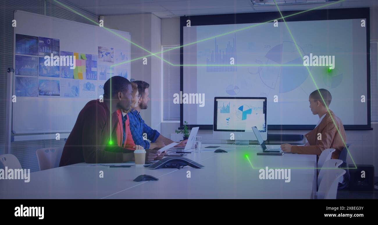 Image of glowing connecting dots against diverse colleagues having a image conference at office Stock Photo