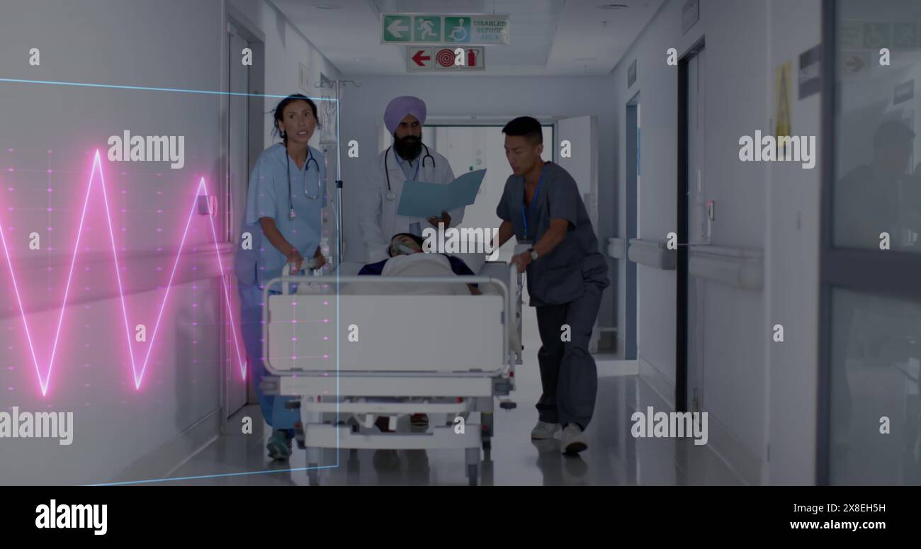 Image of heart rate monitor over team of diverse doctors rushing a patient in operation theatre Stock Photo