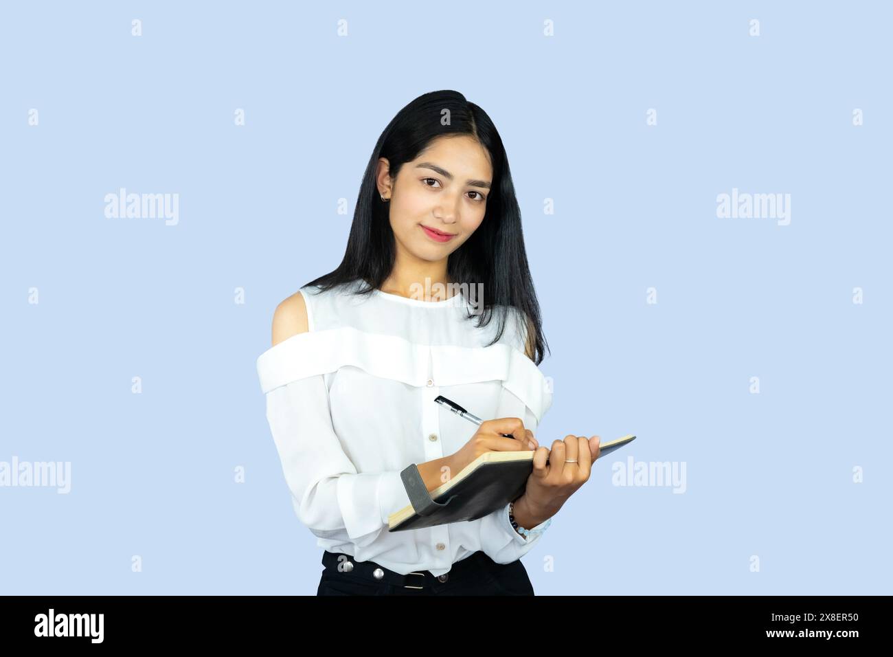 A Young Attractive Beautiful Asian Girl Student with Notepad Working Giving Gestures and Expressions Stock Photo