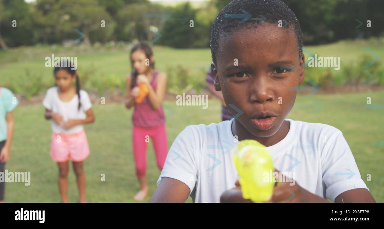 Image of arrows over diverse children at party Stock Photo
