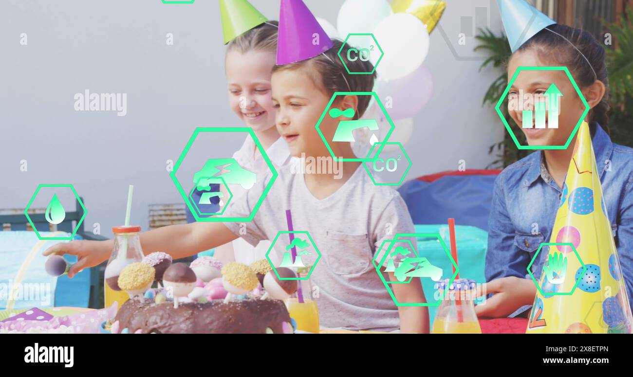 Image of icons over diverse children at party Stock Photo