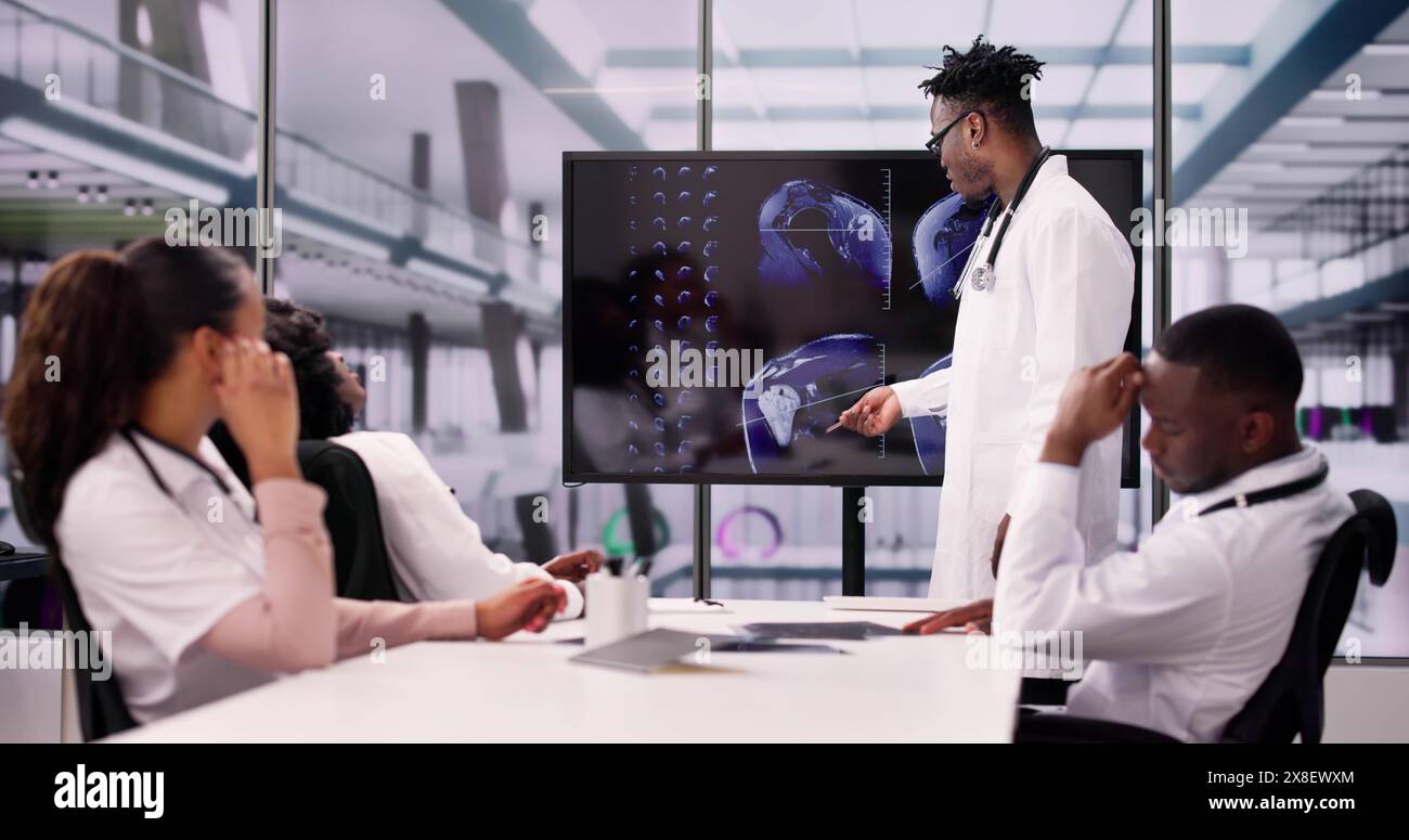 Physician Looking At Shoulder MRT Scan Caucasian Stock Photo