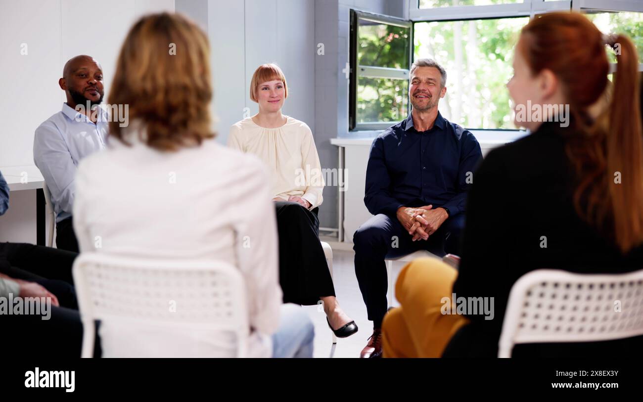 People Consoling Man In Group Therapy Session Stock Photo