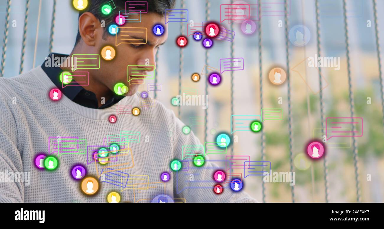 Image of message boxes, profile icons, caucasian man working on laptop and checking smartwatch Stock Photo