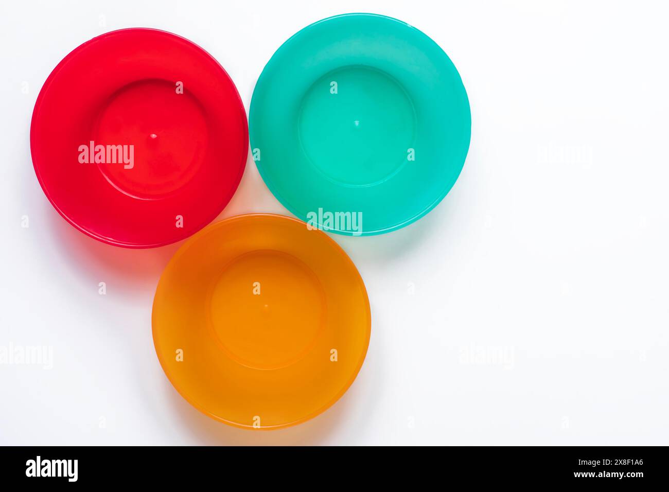 Colorful plastic tableware isolated on white background with copy space. Top view. Stock Photo