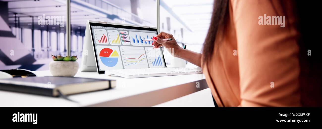 African American Data Analyst Using Data Analytics KPI Dashboard Stock Photo