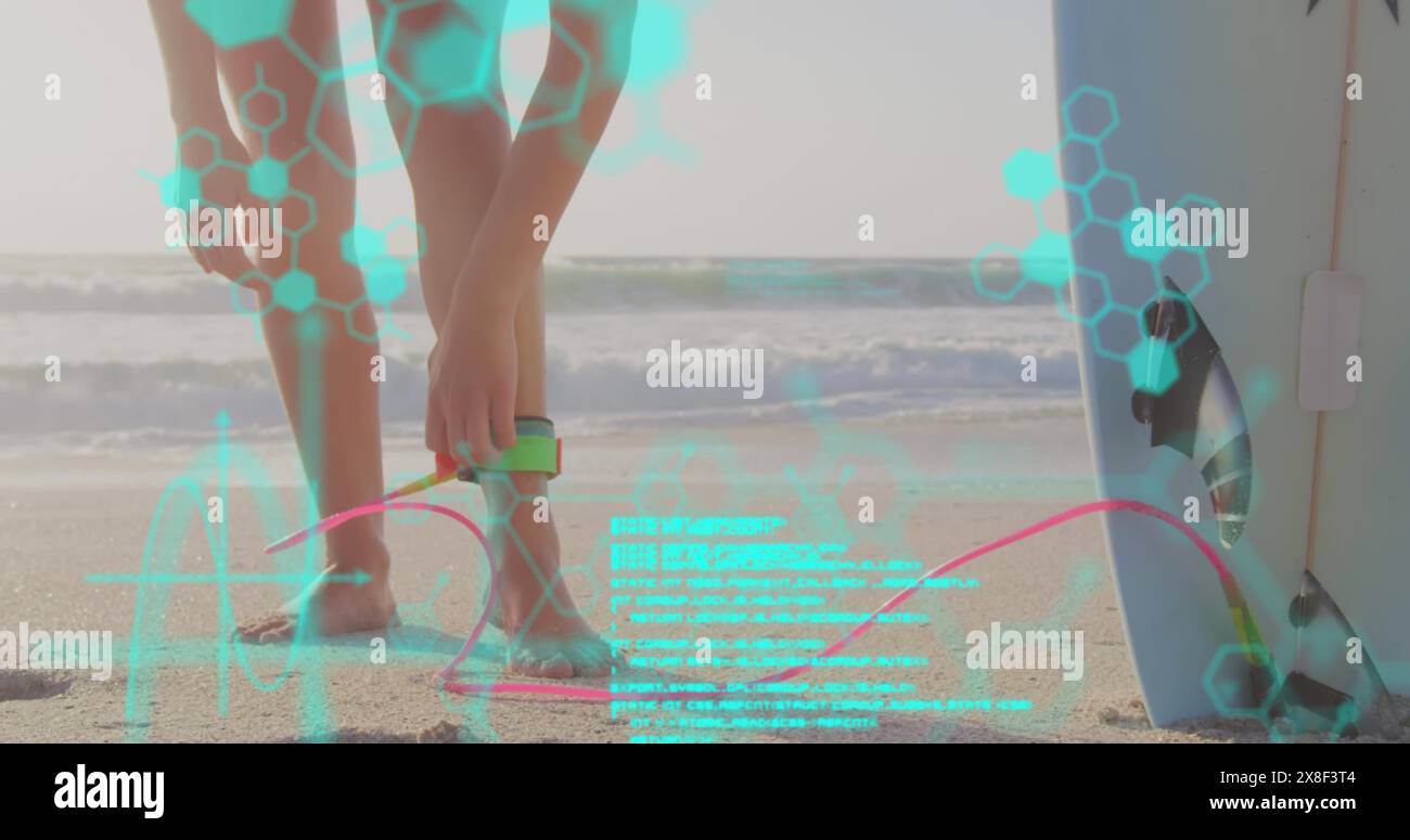 Caucasian athlete wearing smartwatch on beach, analyzing data Stock Photo