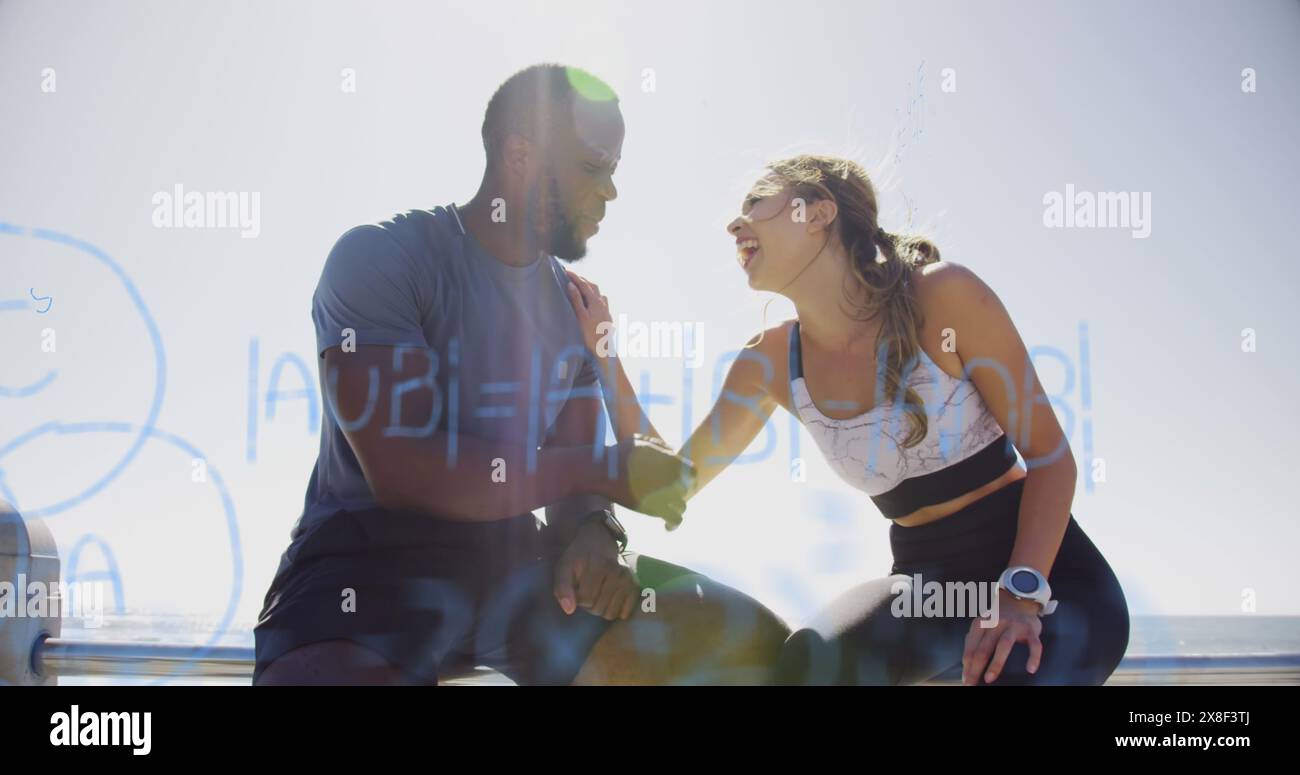 African American coach, biracial athlete in sportswear, sitting in the sun Stock Photo