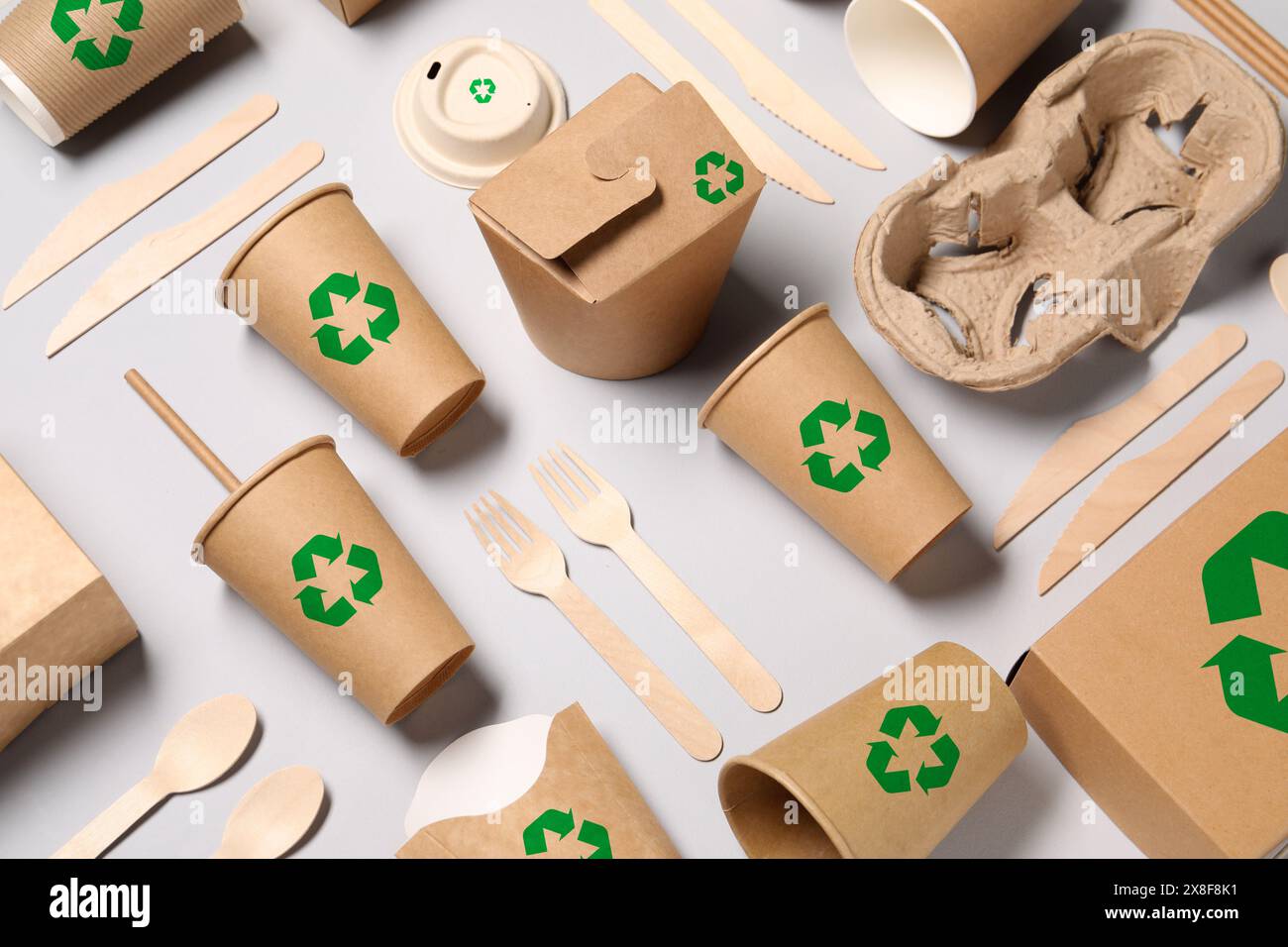 Set of eco friendly food packaging with recycling symbols on light ...