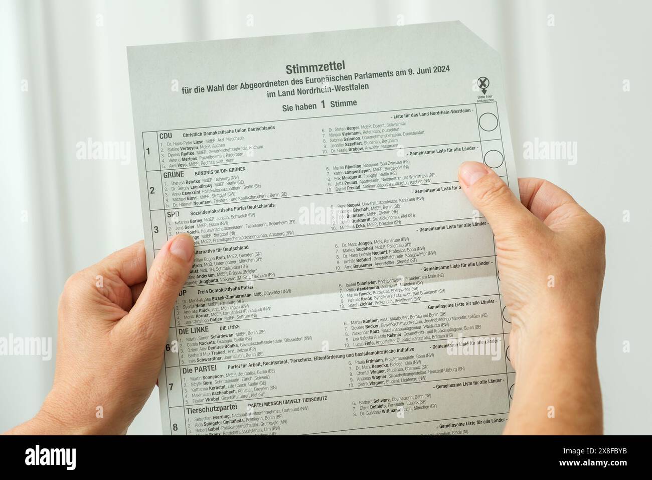 Woman looks at the ballot paper for the postal vote for the 2024