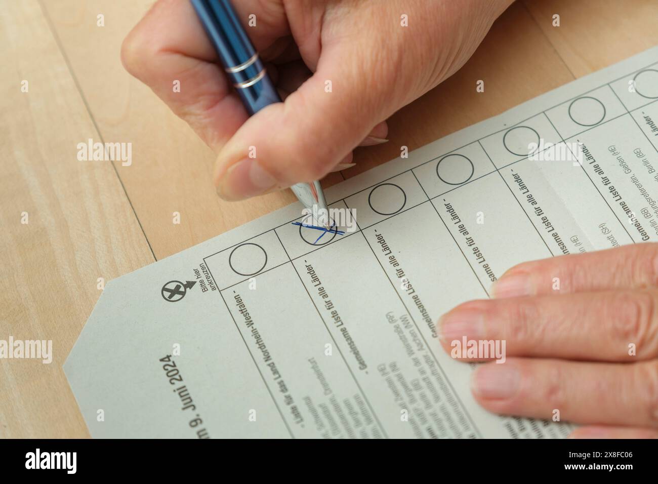 Postal vote Woman fills out the ballot paper for the 2024 European