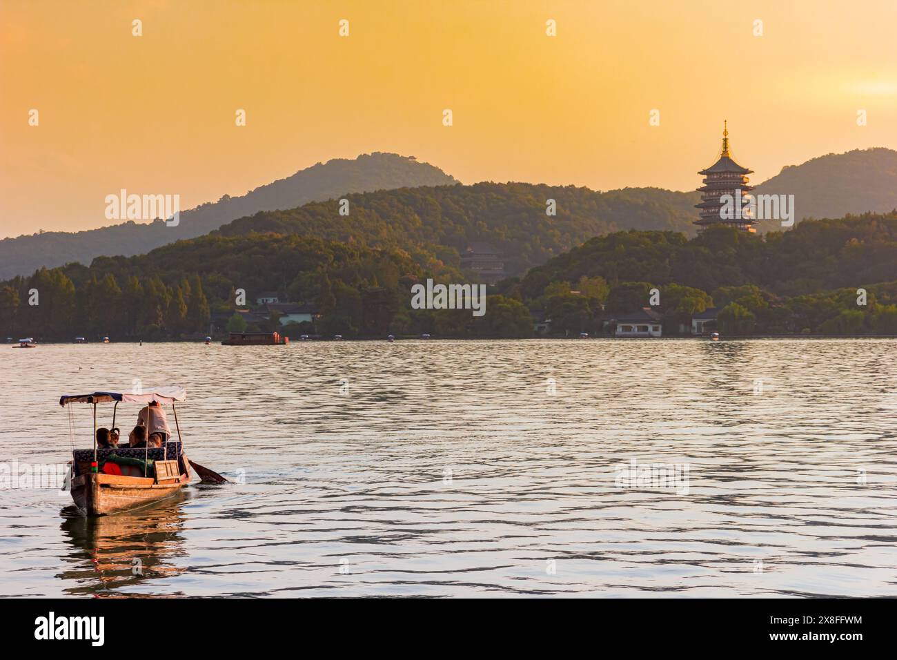 Wooden boat in sunset on the West Lake in Hangzhou, China Stock Photo