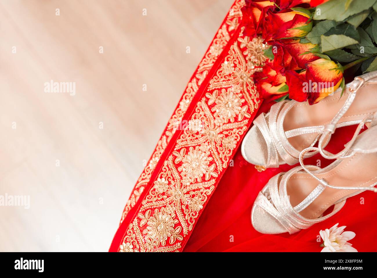 Ceremony, culture and Indian wedding with shoes, flowers and traditional clothes with celebration. Home, designer high heels and bouquet in bedroom Stock Photo